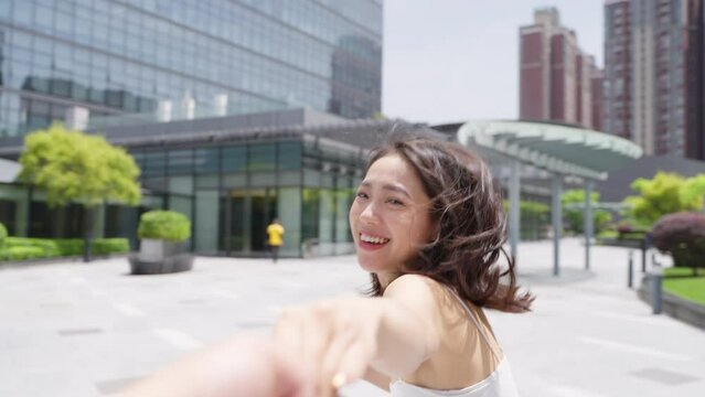 happy asian girlfriend enjoy the holiday holding hand running in the city