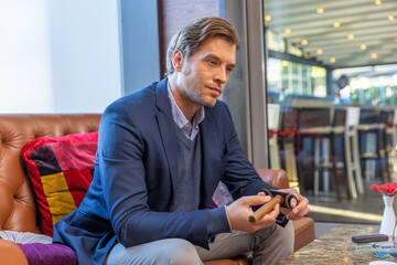 Handsome rich businessman cutting cigar