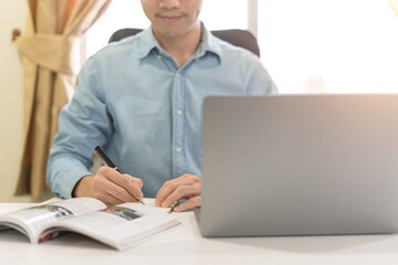 Young businessman or investor learning trading and investing on laptop for stock and Cryptocurrency...