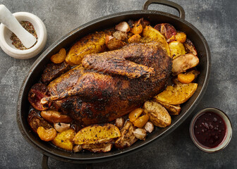 A Christmas recipe for roasted goose stuffed with baked apples, on a gray background