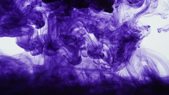 Purple Ink Dissipating In Water On A White Background
