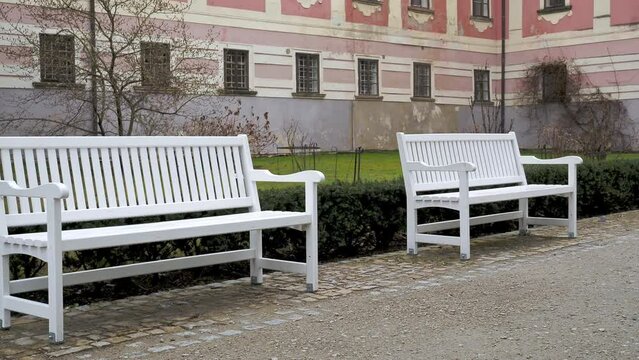 White benches in the castle garden, city Trebon. Czech Republic