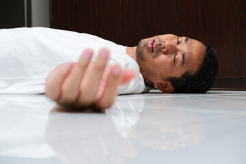 Adult Asian man fainted in the floor