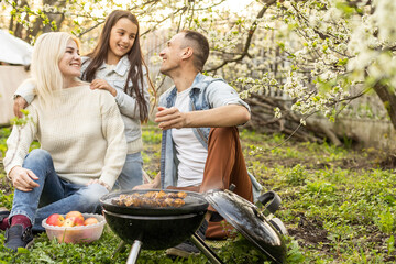 Happy family on summer picnic in park.