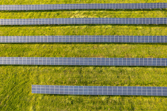 aerial view of solar panels on a sunny day. power farm producing clean energy