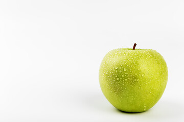 green apple with drops on a white