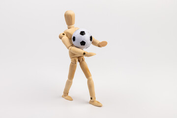 Wooden mannequin with soccer ball isolated on white background. Football player concept.