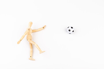 Wooden mannequin with soccer ball isolated on white background. Football player concept.