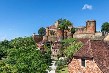 Сommoner settlement located on hill slopes and fortress castle Chateau de Castelnau-Bretenoux in Dordogne Valley, Prudhomat, Lot, Occitanie, France