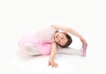 The beautiful little girl is doing gymnastics on a white background