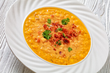 corn chowder in bowl on table, top view