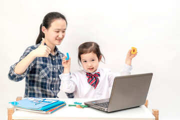Mother and little girl are learning English letters