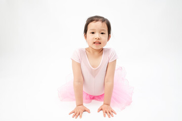 The beautiful little girl is doing gymnastics on a white background