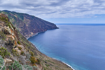 Rocky coast of Madeira with cliffs, coast of the island
