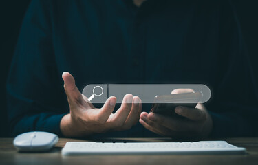 The concept of using technology to search for information, a man's hand is using a smartphone to...