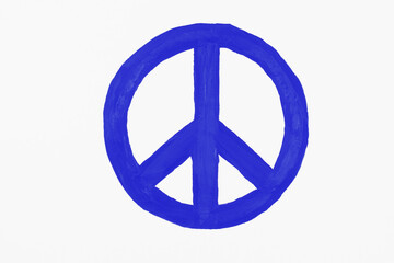 Peace symbol drawn with blue paints on paper.
