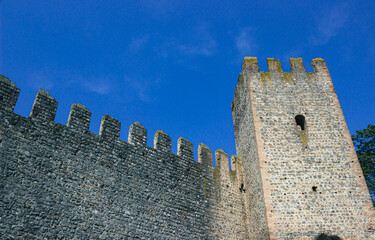 Medieval walls and tower with blue sky background. Carrarese Castle, Este, Italy.