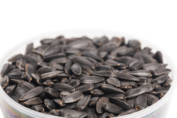 Sunflower seeds in cup isolate on a white background