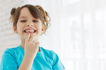 The kid lost a tooth. Baby without a tooth. Portrait of a little girl no tooth. High quality photo - 502536364