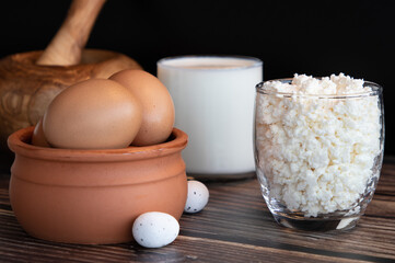 dairy products : milk and cottage cheese and rustic eggs on a wooden background