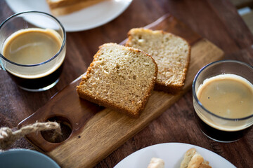 Banana cakes on wooden board with coffee and wooden table.