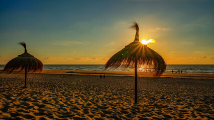 Panoramic landscape background panorama of .Parasol in a Hawaiian look made of straw on the beach...