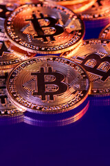 Close up photo of gold plated bitcoins symbolizing the bit coin market and modern technology, finance, internet, trading.