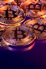 Close up photo of gold plated bitcoins symbolizing the bit coin market and modern technology, finance, internet, trading.
