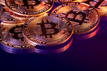 Close up photo of gold plated bitcoins symbolizing the bit coin market and modern technology, finance, internet, trading.
