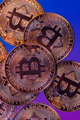 Close up photo of gold plated bitcoins symbolizing the bit coin market and modern technology, finance, internet, trading.