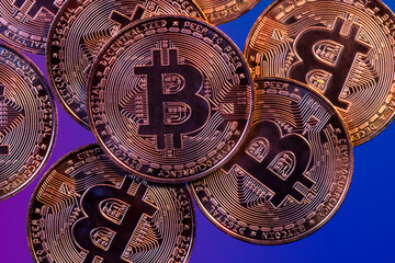 Close up photo of gold plated bitcoins symbolizing the bit coin market and modern technology, finance, internet, trading.