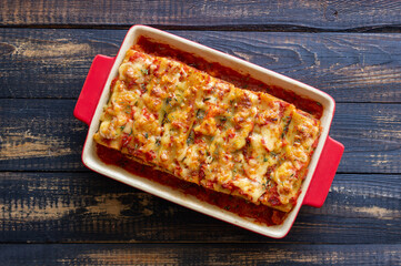 Cannelloni with meat, cheese, tomatoes and thyme. Italian cuisine.