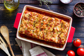 Cannelloni with meat, cheese, tomatoes and thyme. Italian cuisine.