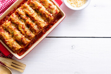 Cannelloni with meat, cheese, tomatoes and thyme. Italian cuisine.
