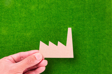 brown factory holding over green