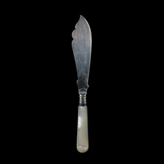 engraved antique silver knife. vintage cutlery for table setting on black isolated background