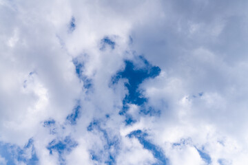 White clouds in the blue sky. Clear heaven on a clear, fine summer day. Rain clouds