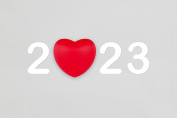 Fototapeta na wymiar 2023 with red heart symbol on white fabric texture background for Happy New Year.