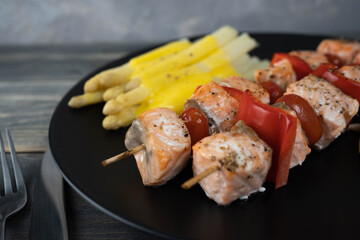 Baked salmon with asparagus on gray background. Mediterranean diet concept. White asparagus with hollandaise souce.