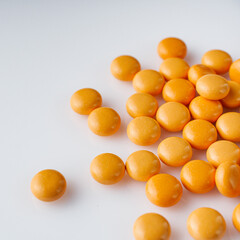 orange valerian pills on a white acrylic background