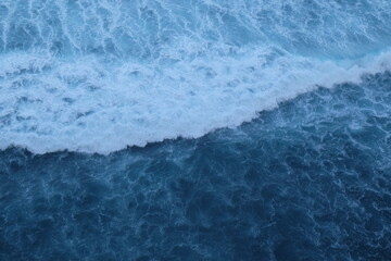 Fototapeta na wymiar Beautiful scenic view of ocean with powerful waves in Bali island, Indonesia. Blue water background