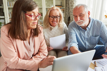 Tax consultant and couple of seniors at the laptop computer