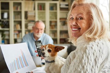 Senior couple with calculator at bookkeeping