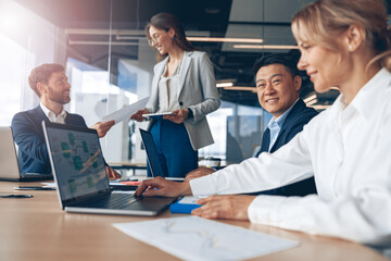 A group of creative businessman during a set team meeting in the modern office. Teamwork concept