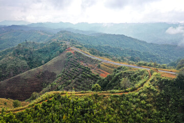 Naklejka na ściany i meble Aerial view of Curvy road number 3 in the mountain of Pua district, Nan province, Thailand