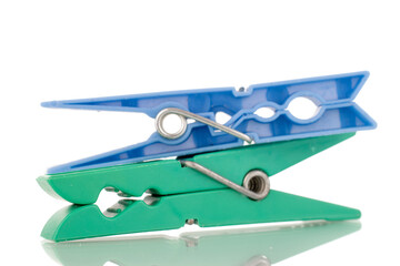 Two plastic clothespins, macro, isolated on a white background.