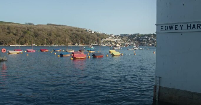 Traditional Wooden Boats Moored At Fowey Harbour In England, United Kingdom. - Low zoom forward