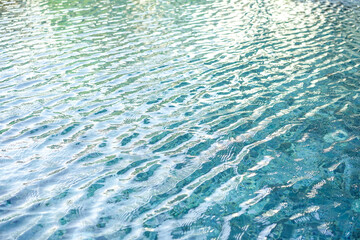 surface of blue swimming pool,background of water in swimming pool. close up clean and clear water background , blue water ripples texture.