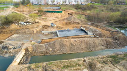 Concrete sewer pipes for laying external sewage system at construction site. Storm sewer collector...