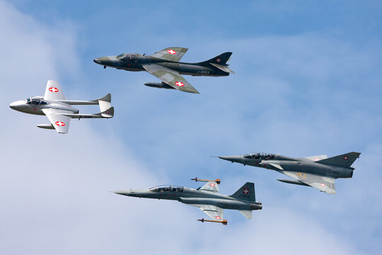 Payerne, Switzerland - September 7, 2014: Formation of former Swiss Air force jet aircraft comprised of a de Havilland Vampire, Hawker Hunter, Northrop F-5 and Dassault Mirage.